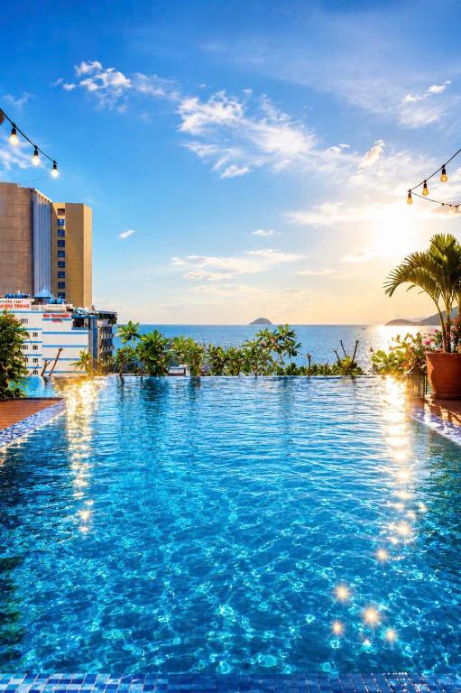 a swimming pool with a view of the ocean at Autumn Sea Boutique Hotel in Nha Trang