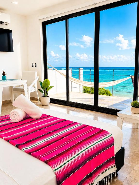 a living room with a large bed and a view of the ocean at Studio RoofTop with amazing view in Mahahual