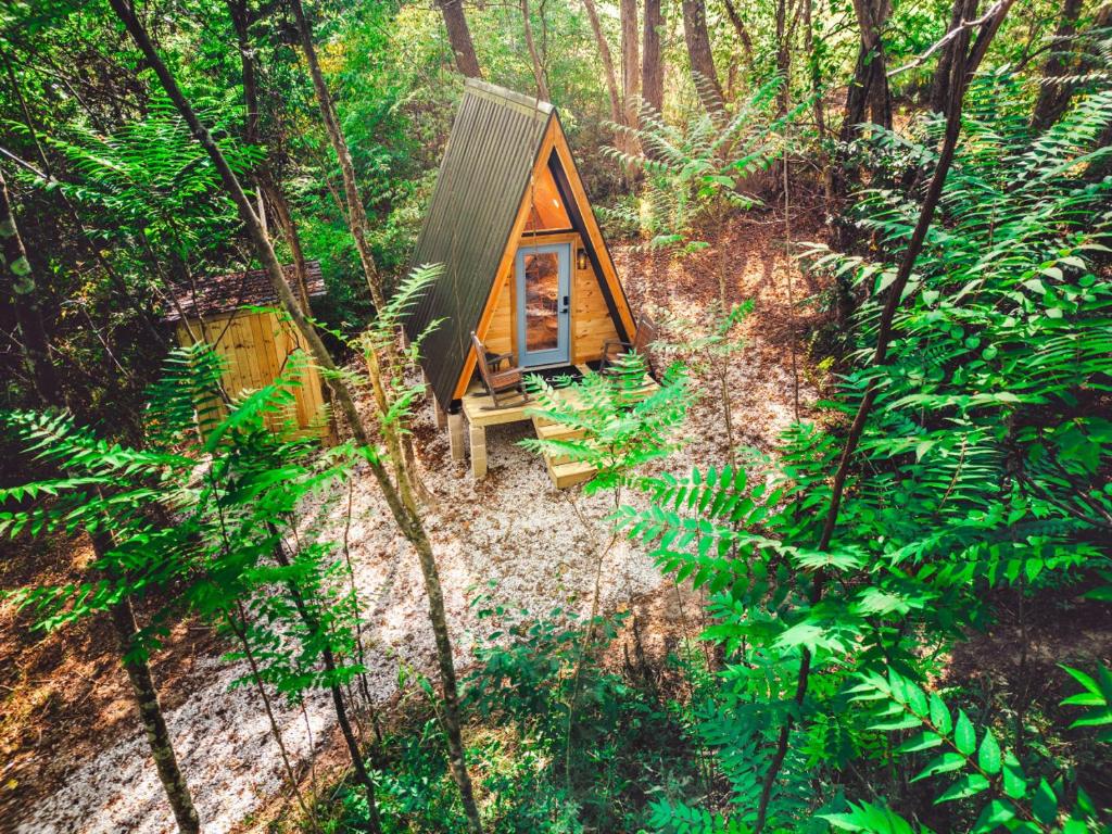 a small cabin in the middle of a forest at Charming A-Frame Couples Retreat Cozy and Private in Rockbridge