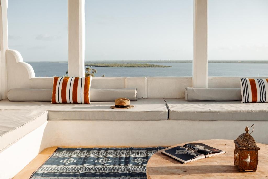 a living room with a view of the ocean at Lamu Treasures Shela Kenya in Shela