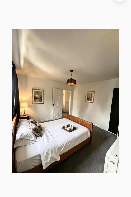 a bedroom with a large white bed with a tray on it at 13a Avon road in Worcester