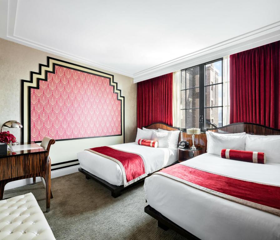 a hotel room with two beds and a desk at Walker Hotel Greenwich Village in New York