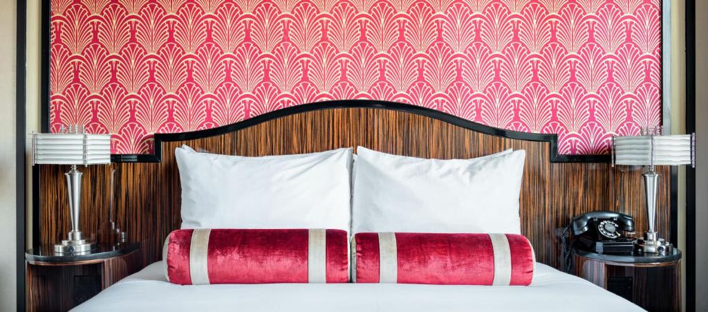 a bedroom with a bed with a red and white headboard at Walker Hotel Greenwich Village in New York