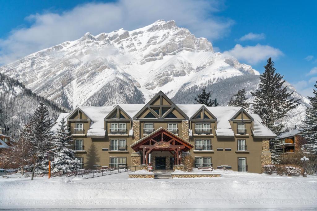 un bâtiment avec une montagne enneigée en arrière-plan dans l'établissement Banff Inn, à Banff