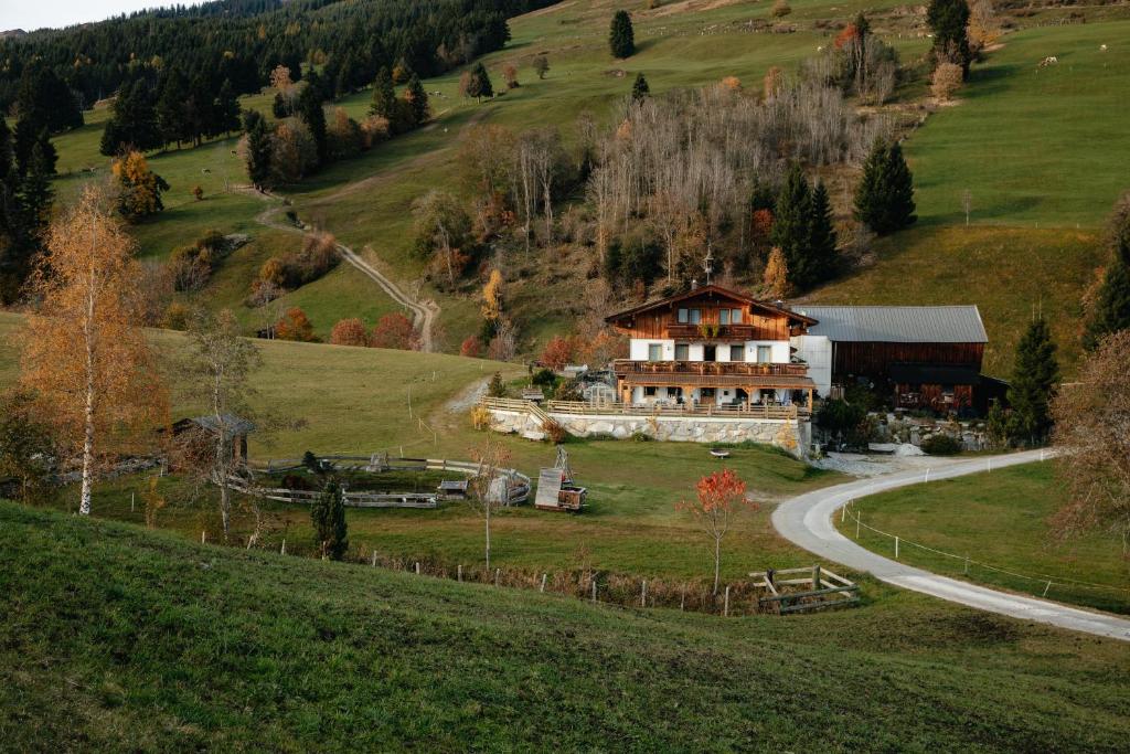 a large house on a hill next to a road at Stanglehen in Mittersill