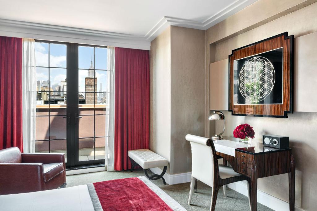 a hotel room with a desk and a window at Walker Hotel Greenwich Village in New York