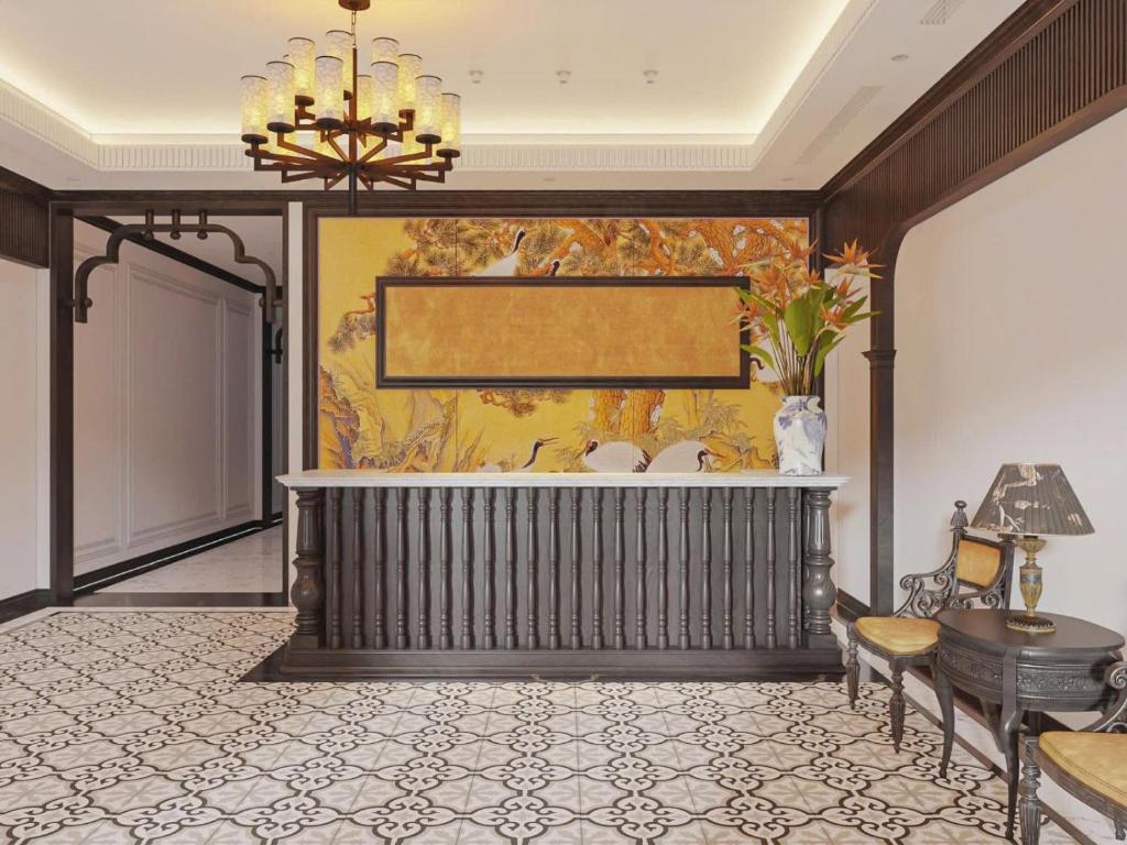 a lobby of a hotel with a tub and a chandelier at LA Resident IndoChine Hotel in Vientiane