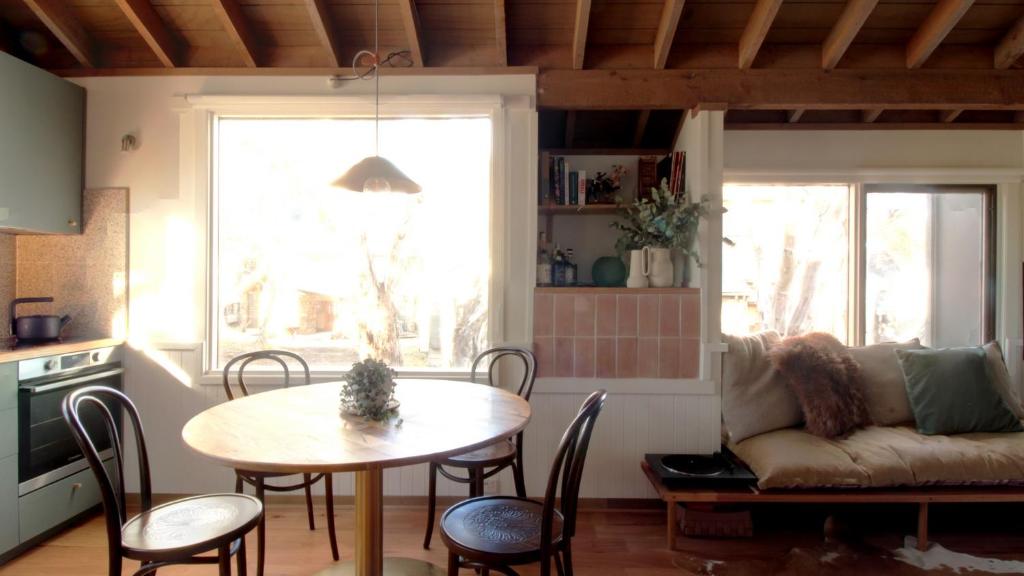 a living room with a table and a couch at Burramys in Dinner Plain