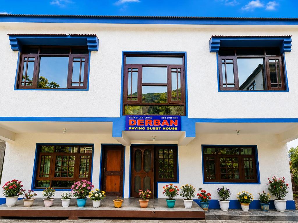a white building with a sign on it at Derban guest house in Srinagar