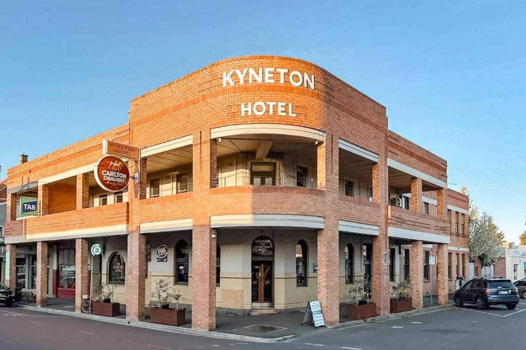 a red brick building with a hotel sign on it at The Kyneton Hotel in Kyneton