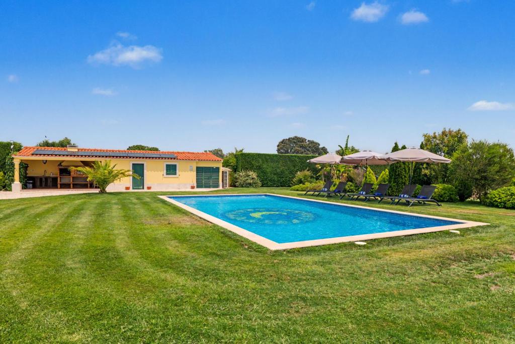 a swimming pool in the yard of a house at Rocha's House - Setúbal in Setubal