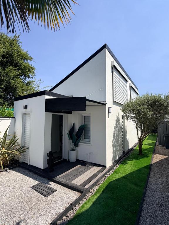a white house with a black roof at Little White House in Anglet