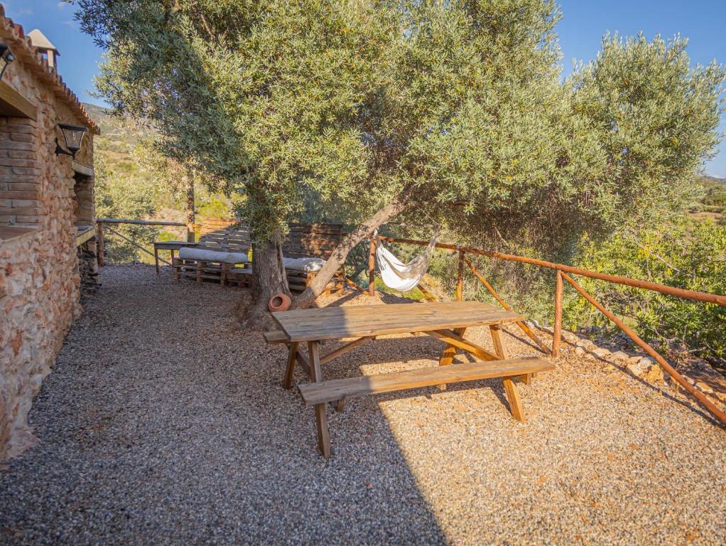 a picnic table and a hammock under a tree at Can Rata in Tivenys