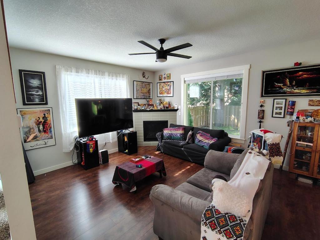 a living room with a couch and a flat screen tv at Evergreen House in Vancouver