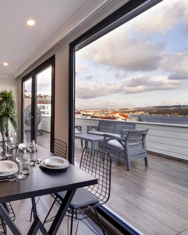 a balcony with tables and chairs and a large window at Etiz Hotels & Residences in Istanbul