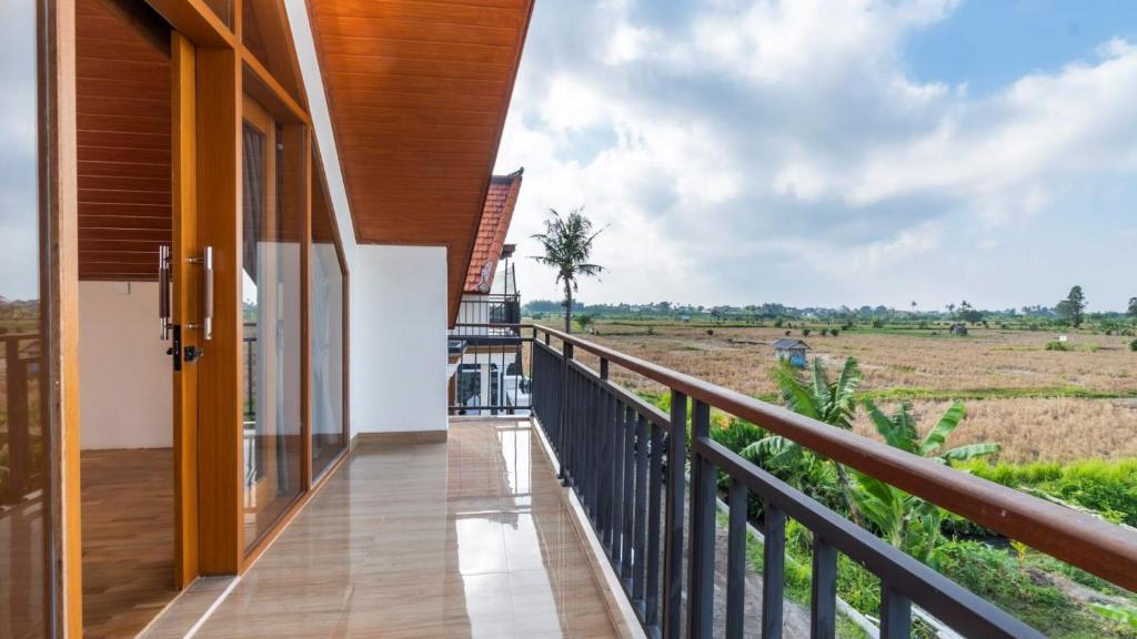 a balcony with a view of a field at Private Villa close to Ubud in Darmasaba