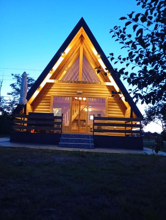 a log cabin with a thatched roof at Brvnara kao na dlanu 2 in Rudnik