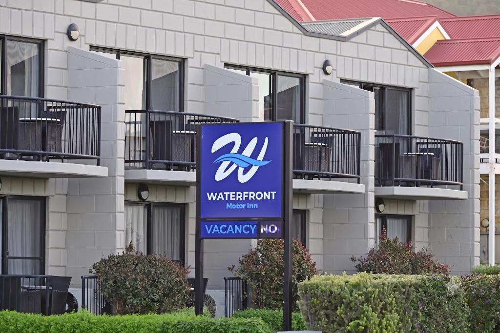 a sign in front of a building at Apollo Bay Waterfront Motor Inn in Apollo Bay