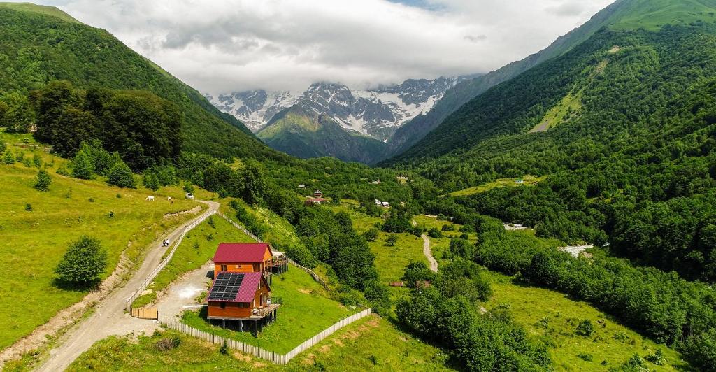a house on a hill with mountains in the background at SkyGona Alpine Retreat in Ghebi