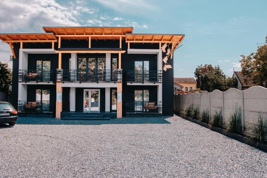 a house with a balcony and a fence at Butterfly in Hunedoara