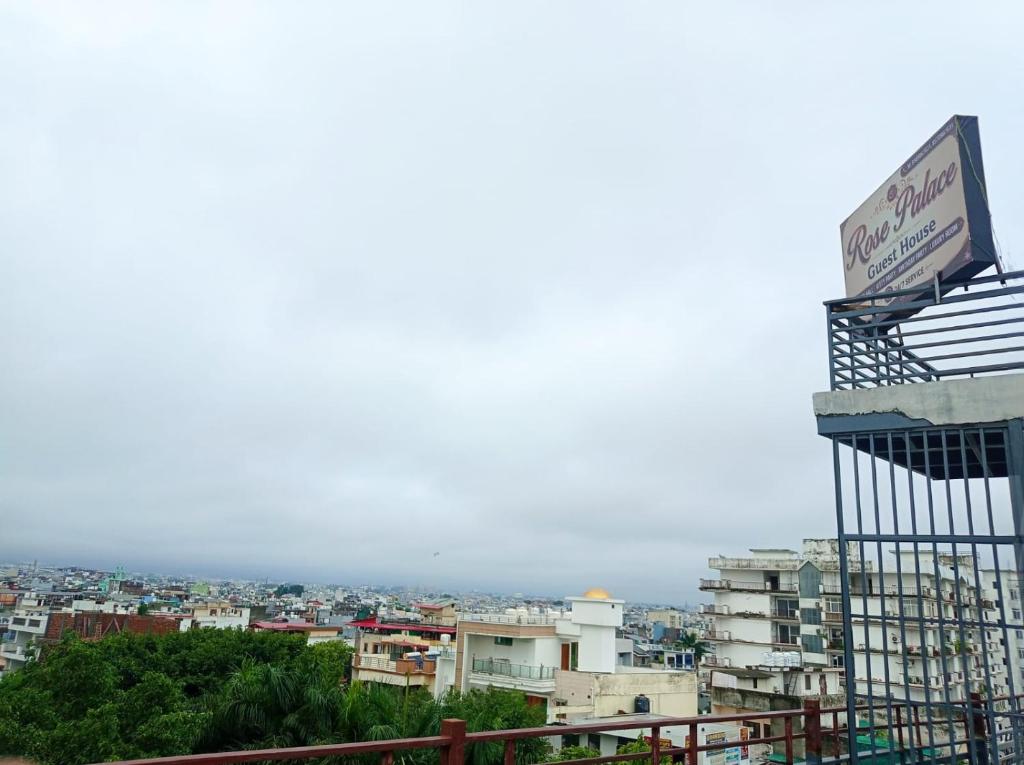 a view of a city with a sign on a building at Hotel rose palace in Dehradun