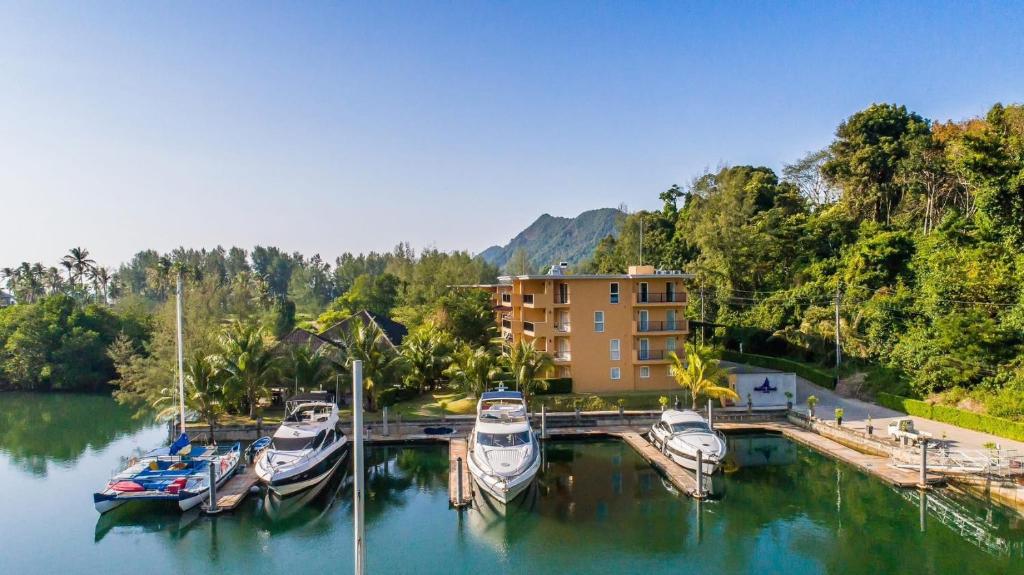 a group of boats are docked at a marina at Marina Sands Resort in Ko Chang