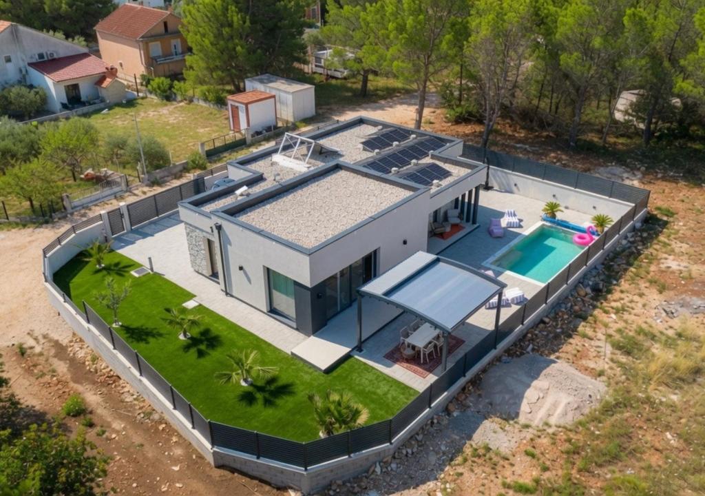 an aerial view of a house with a swimming pool at Casa Palmera in Pridraga