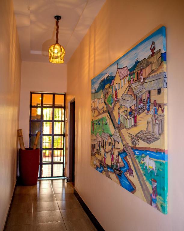 a large painting on the wall in a hallway at Kivulini Homes in Moshi