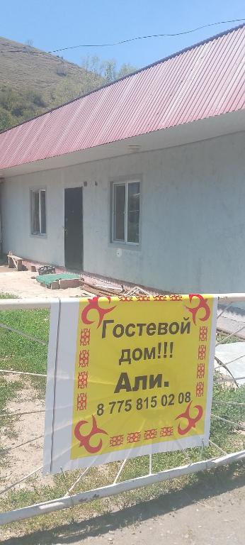 a sign on a fence in front of a house at House Ali in Klyuchi