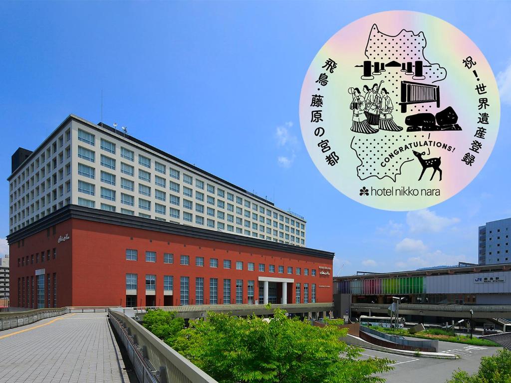 a large building with a sign in front of it at Hotel Nikko Nara in Nara