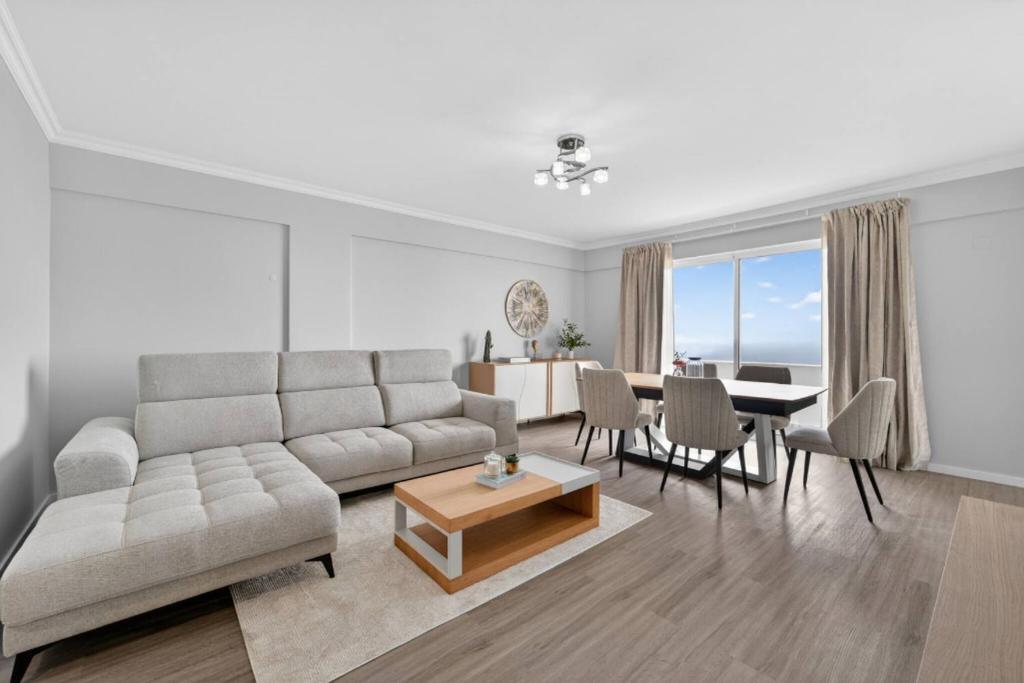 a living room with a couch and a table at Calheta Atlantic Pearl in Calheta