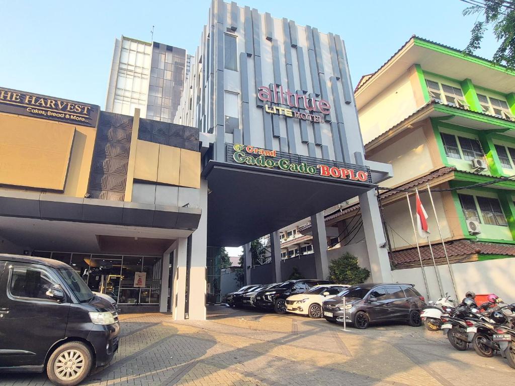 a group of cars parked in front of a building at Alltrue Lite Senen Jakarta in Jakarta