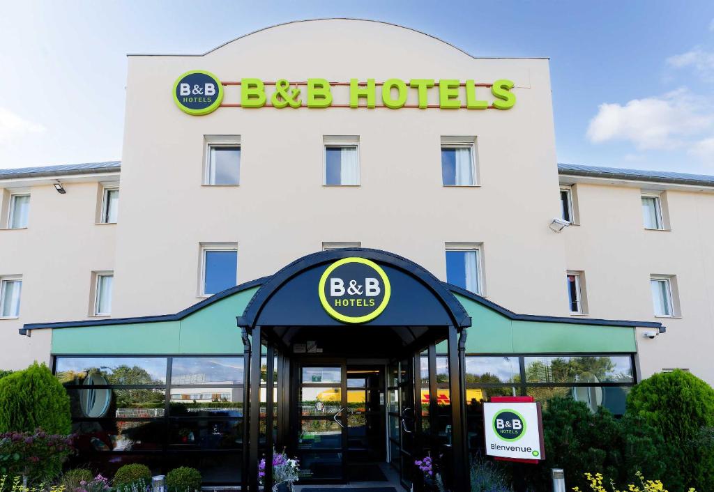 a hotel entrance with a berk hotels sign above it at B&B HOTEL Reims Tinqueux in Reims