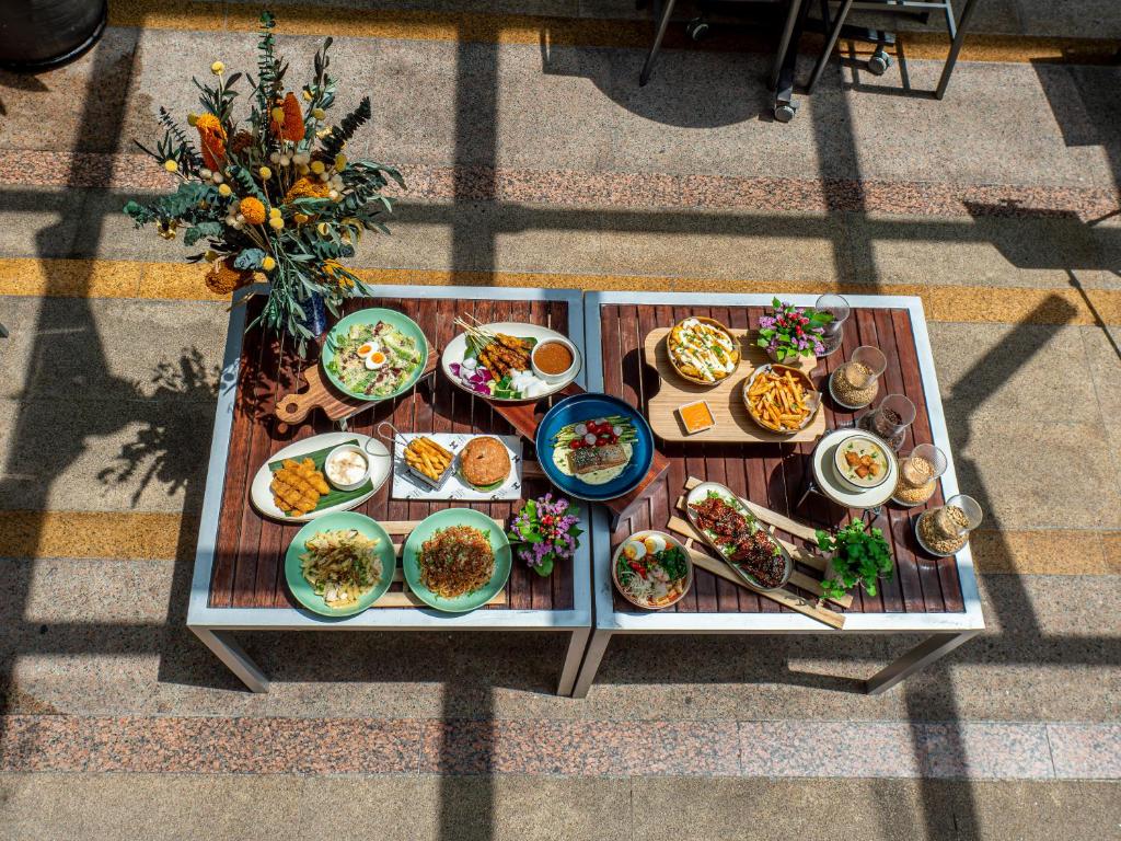 A sunlit table display of assorted plated dishes and drinks.