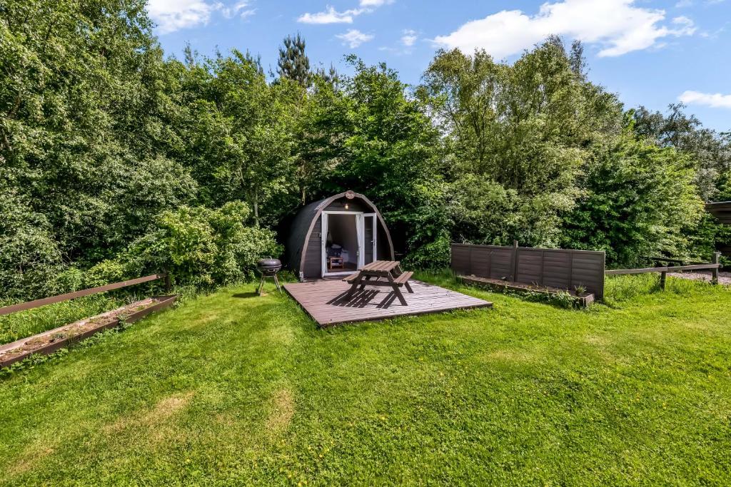 a tent in a yard with a picnic table in the grass at Dreish - Glamping Pod in Forfar