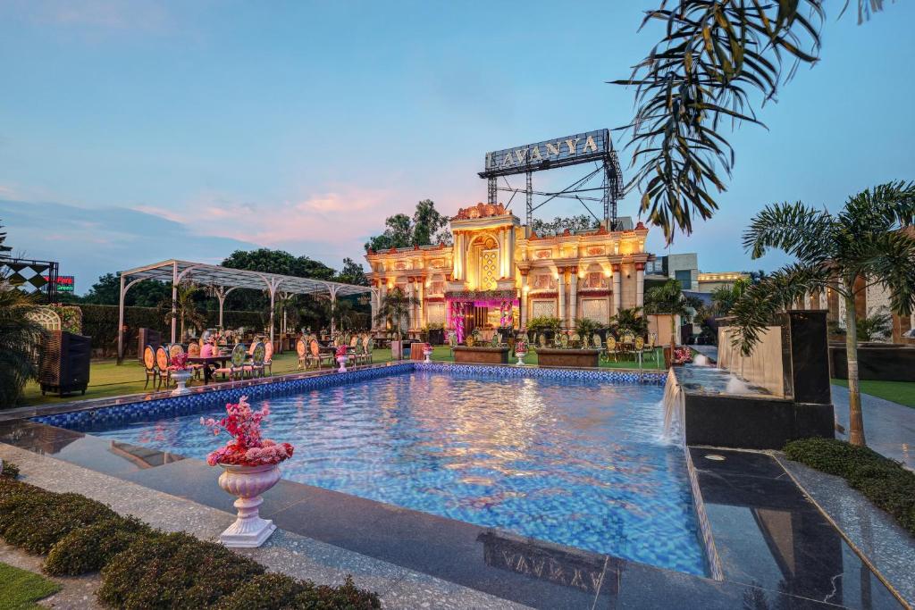 a large swimming pool in front of a building at Lavanya Hotel- Near Alipur, Delhi in New Delhi