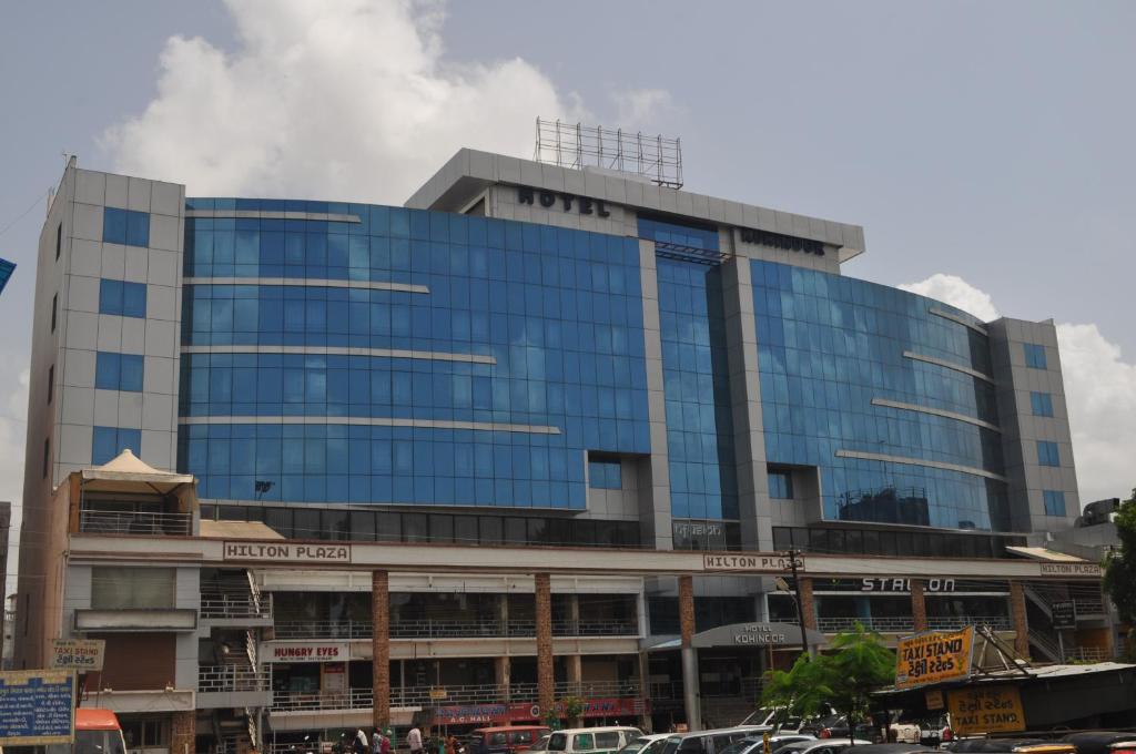 a large glass building with smoke coming out of it at Hotel Kohinoor, Bharuch in Bharūch