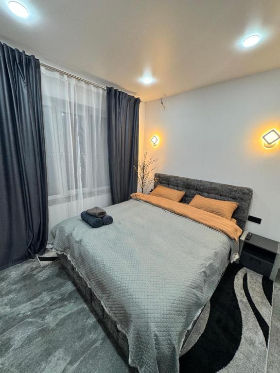 a bedroom with a large bed in front of a window at APARTMENT Ultra central in Edineţ
