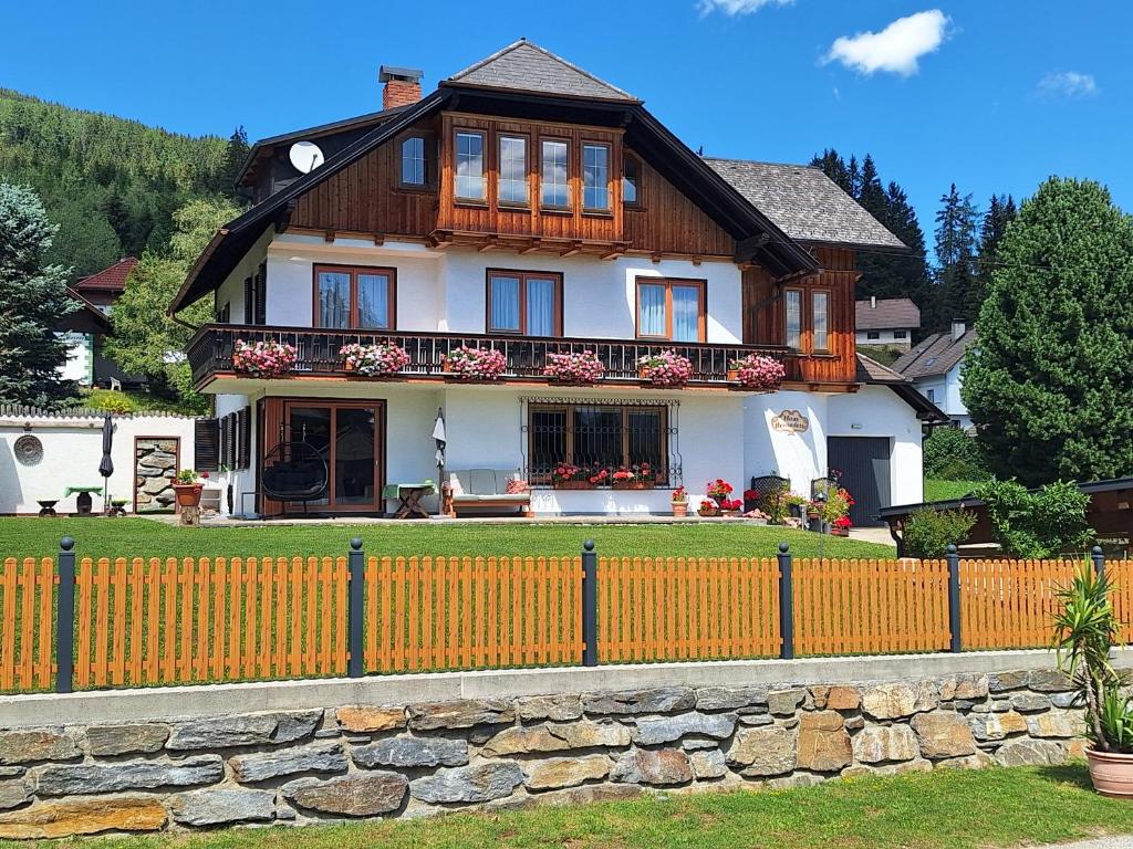 a large house with a fence in front of it at Ferienhaus Bernadette in Mauterndorf