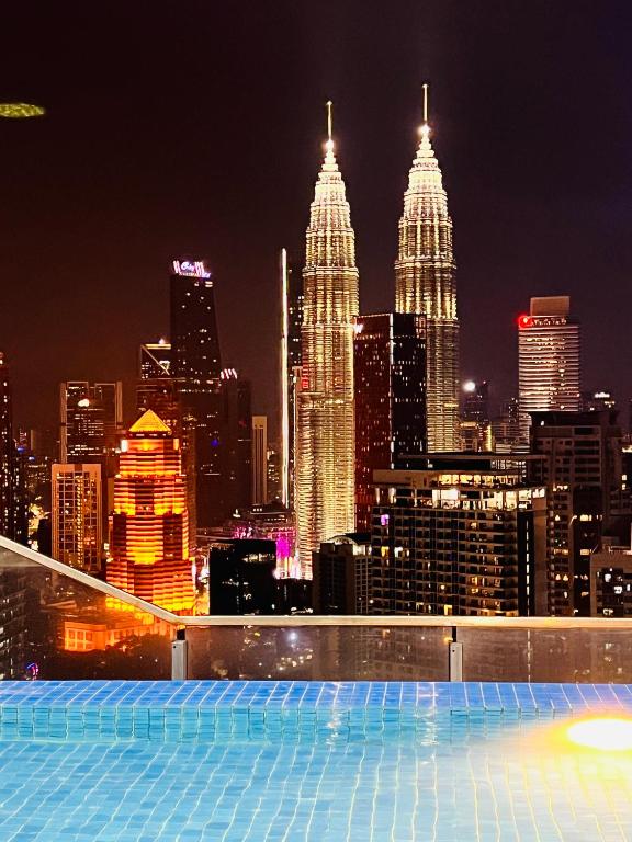 a view of a city skyline at night at The Luxe Service Suites in Kuala Lumpur