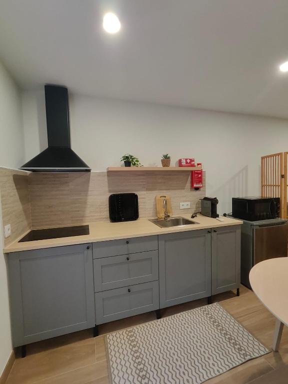 a kitchen with a sink and a counter top at Gondar Stays Estúdio 