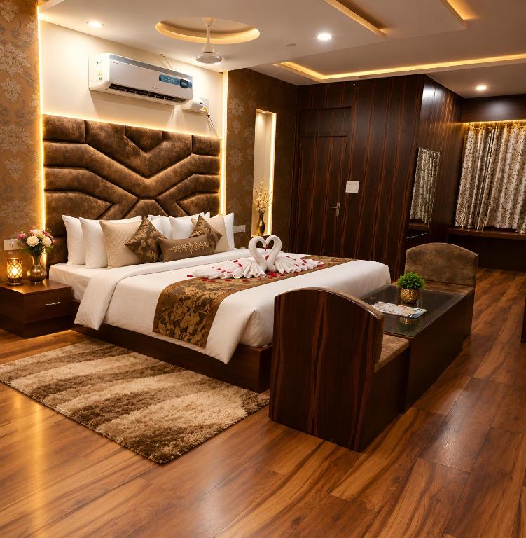 a bedroom with a large bed and a desk at Hotel KMG Air Cooled,Zirakhpur Chandigarh ,Couple first choice ,verified hotel in Zirakpur