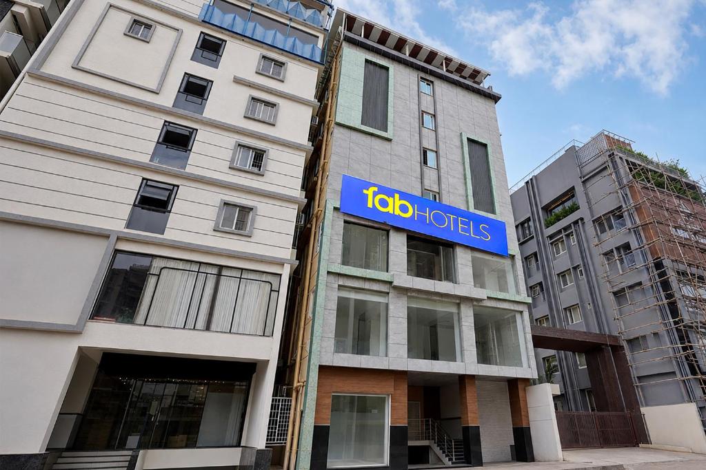 a building with a sign on the side of it at FabHotel Blue Birds in Bangalore