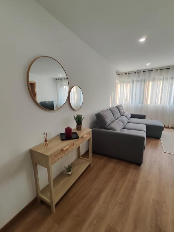 a living room with a couch and a mirror at Gondar Stays T1 