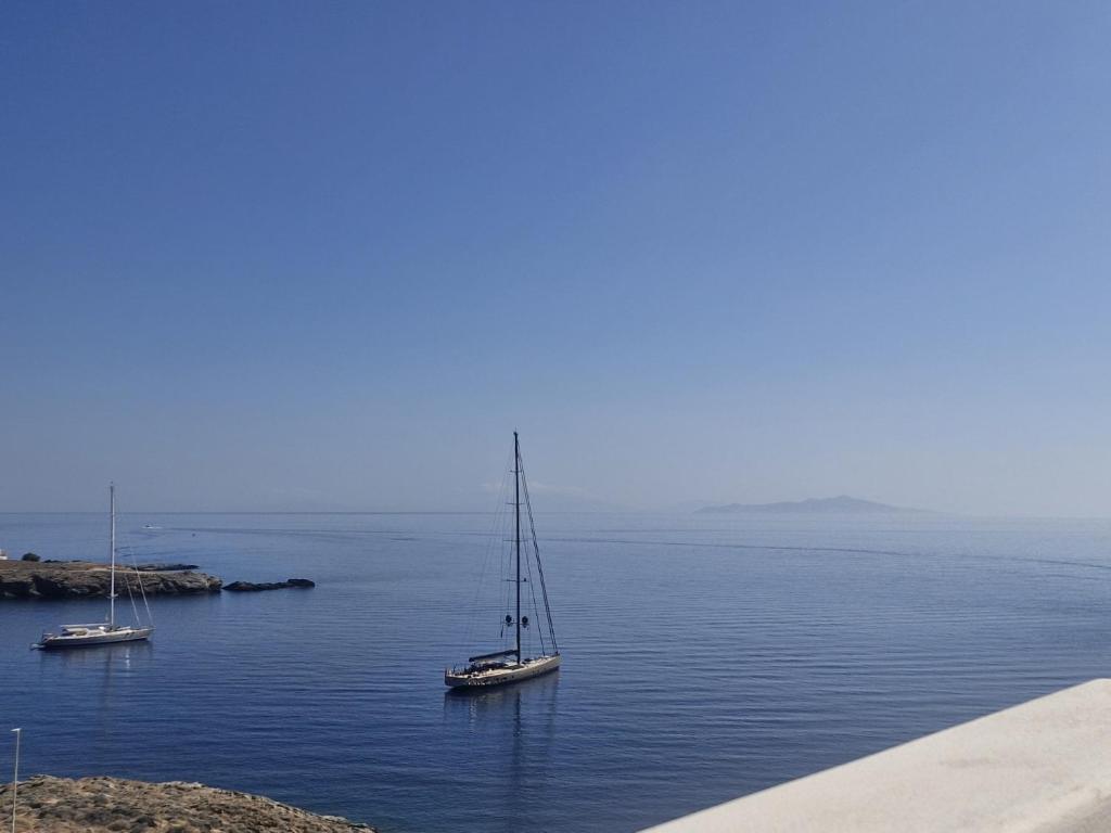 two boats in a large body of water at Faros House Kythnos in Loutra