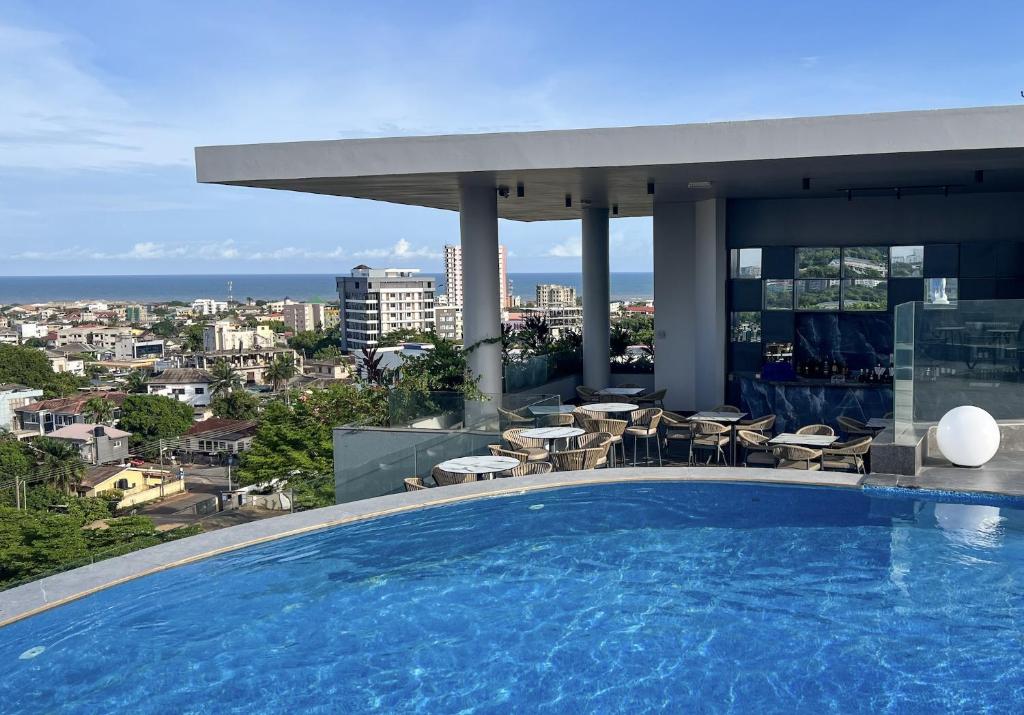 a large swimming pool on top of a building at Anthonian Suites in Accra