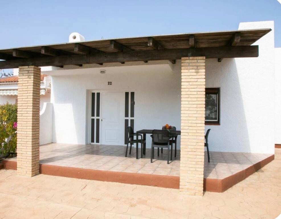 a patio with a black table and chairs at Casa en Riumar in Riumar