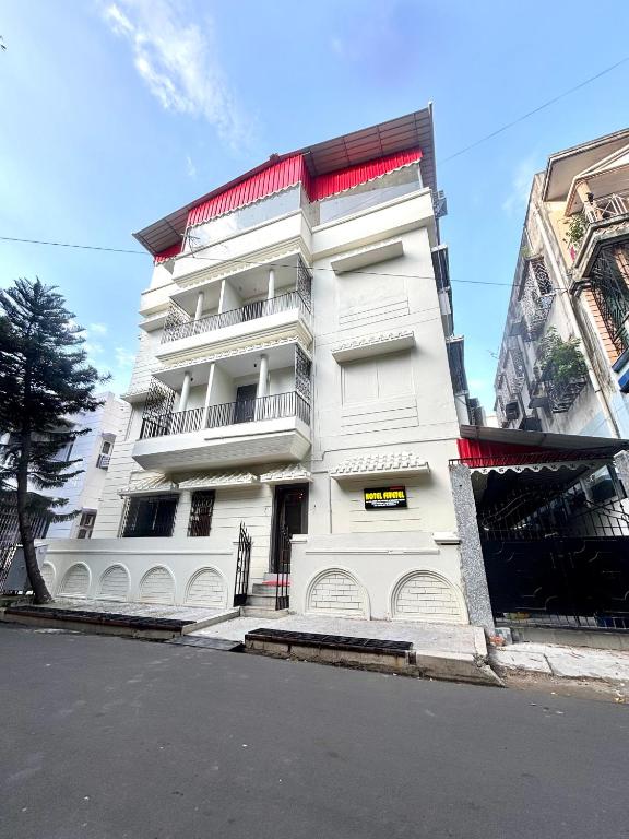 a white apartment building with aventh floor at Hotel Fivetel in kolkata