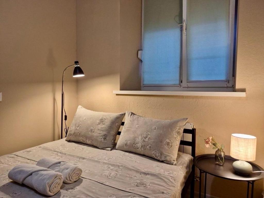 a bedroom with a bed with a window and a table at Podil-House-Hotel in Kyiv