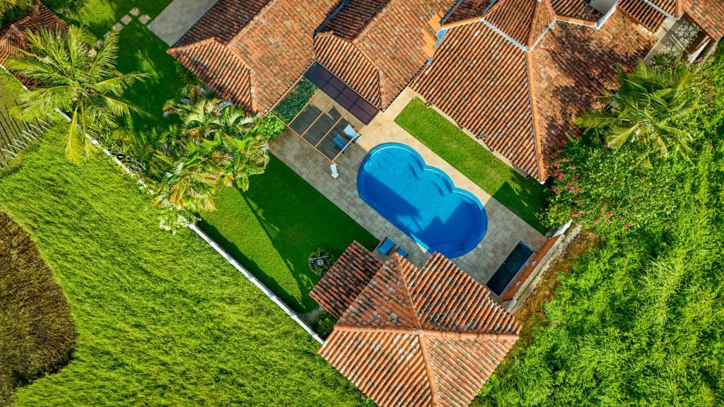 an overhead view of a house with a blue lawn at Cathaya Private Pool Villa - Limasan Padi in Langkawi Intl